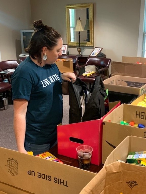 Volunteer packing backpacks