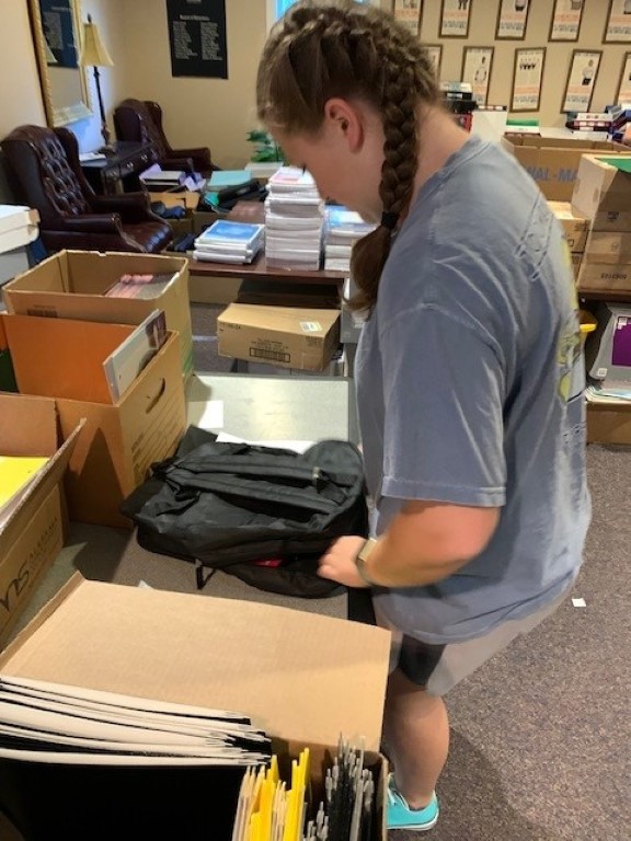 Volunteer packing backpacks