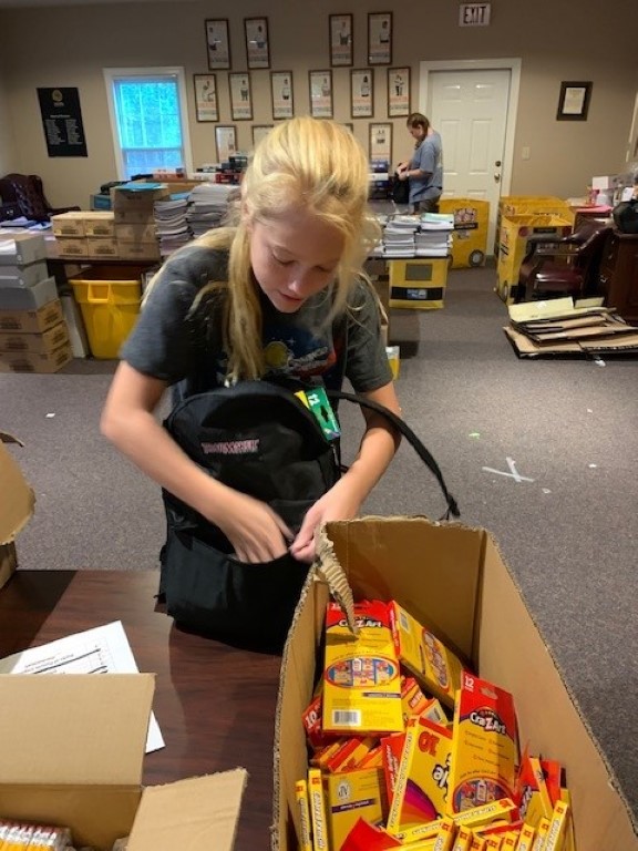 Volunteer packing backpacks