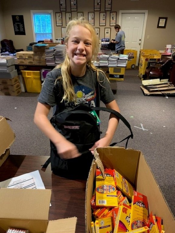 Volunteer packing backpacks