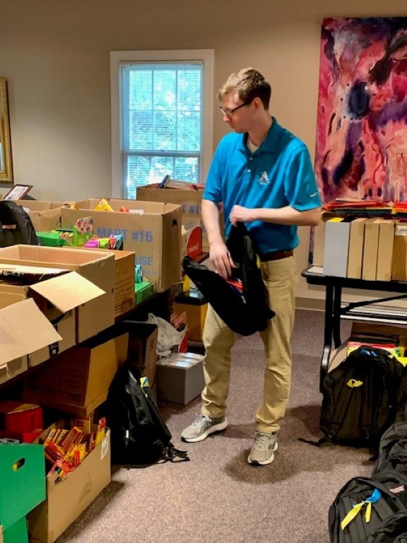 Volunteer packing backpacks