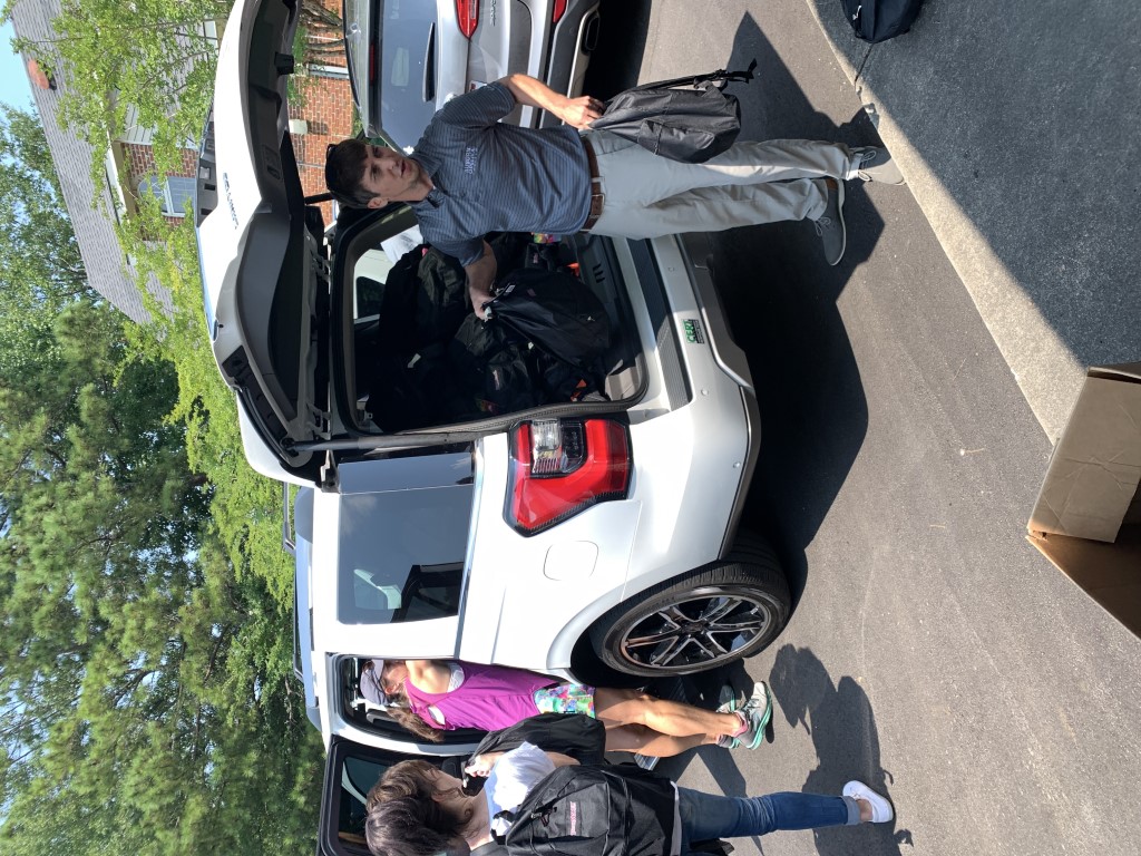 Volunteers transporting backpacks