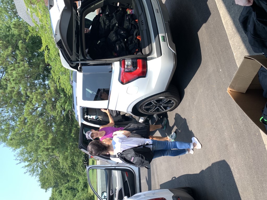 Volunteers transporting backpacks