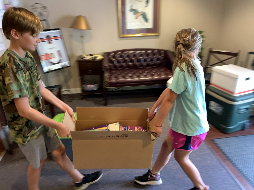 Volunteers transporting backpacks